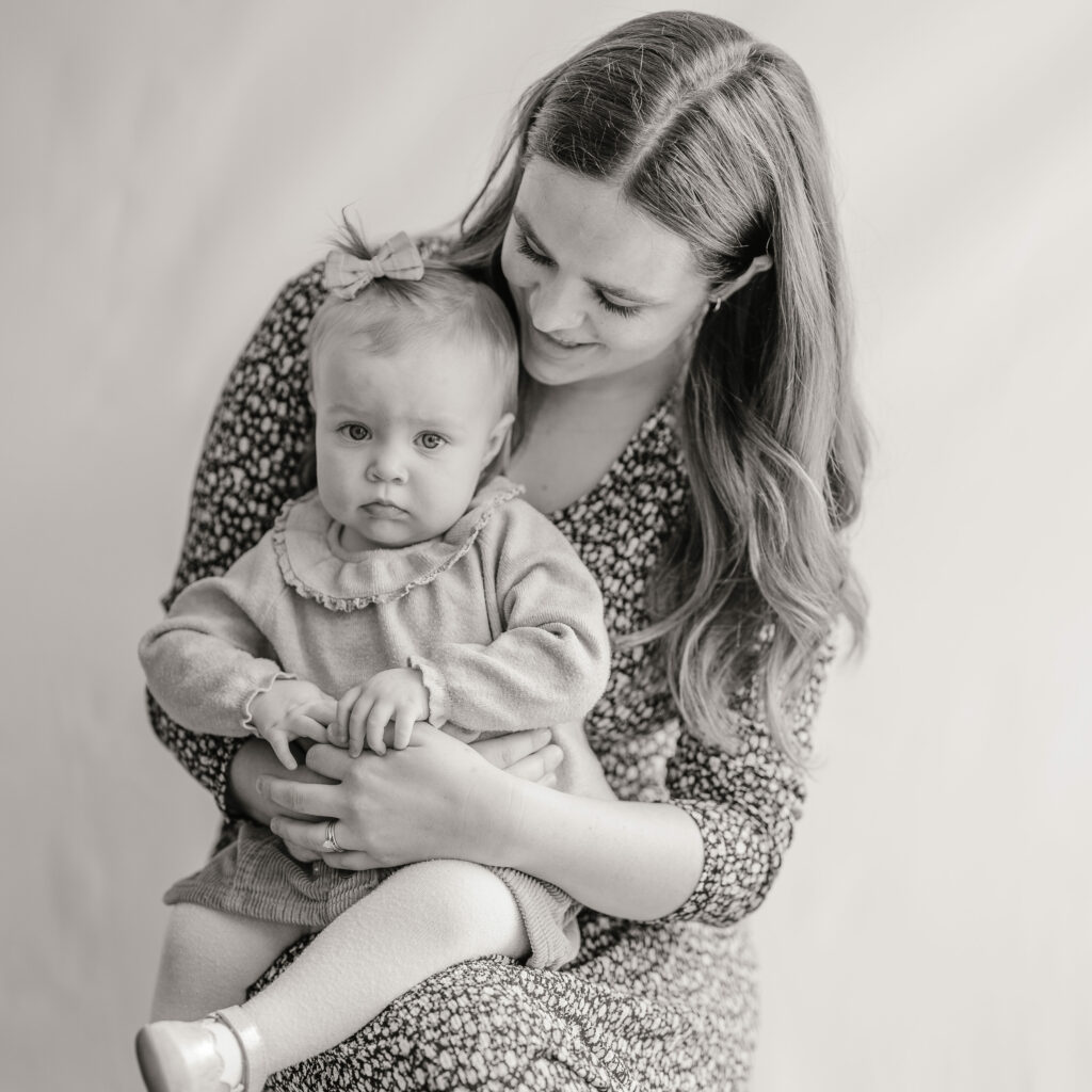 Toddler sitting on mothers lap in clothes from Kid to Kid