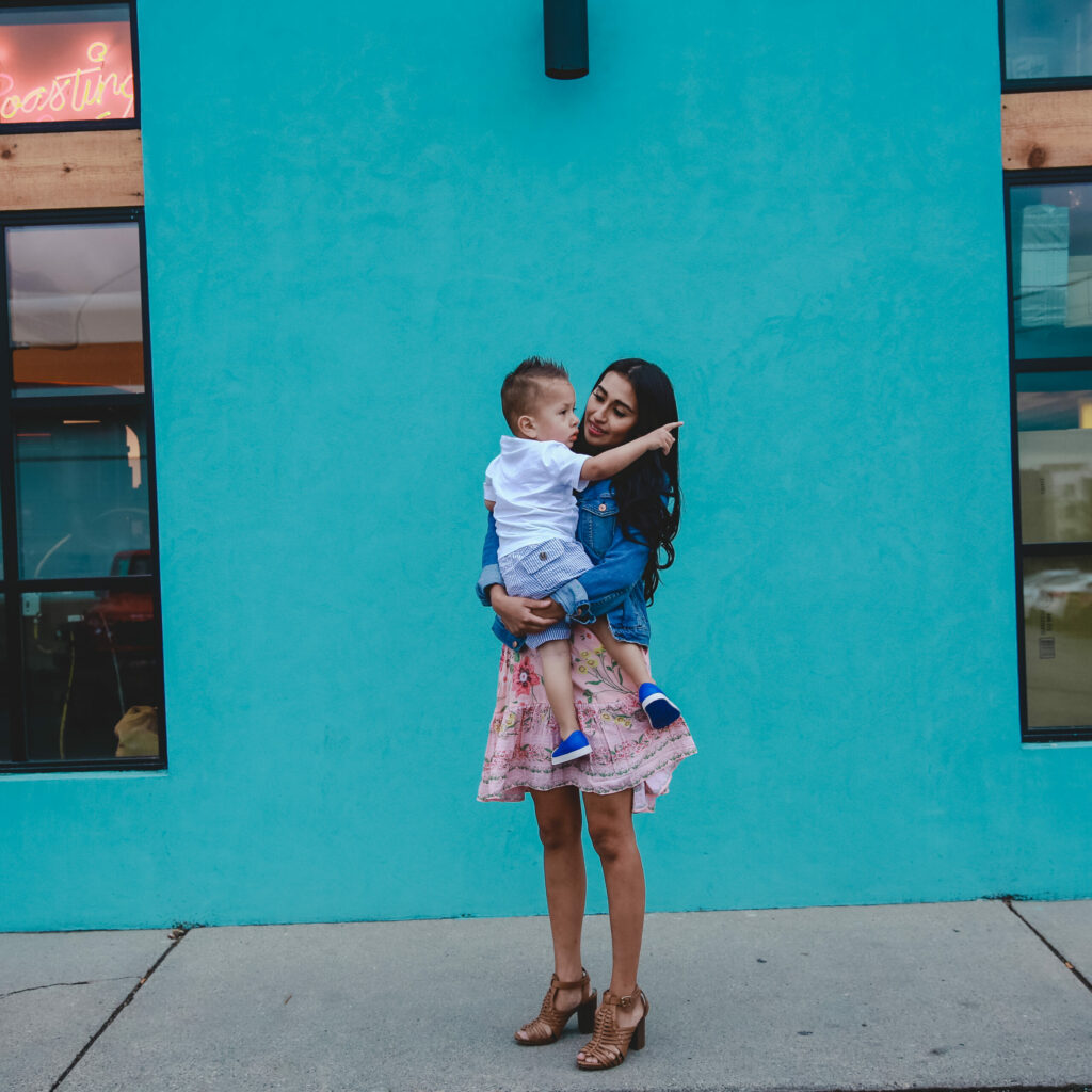 Mother outside a building holding her son