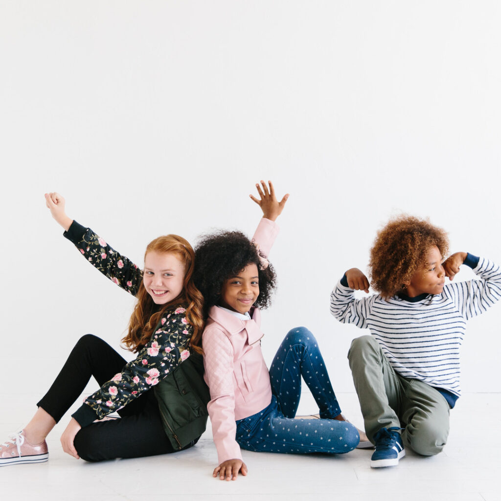 two girls and a boy in clothes from kid to kid