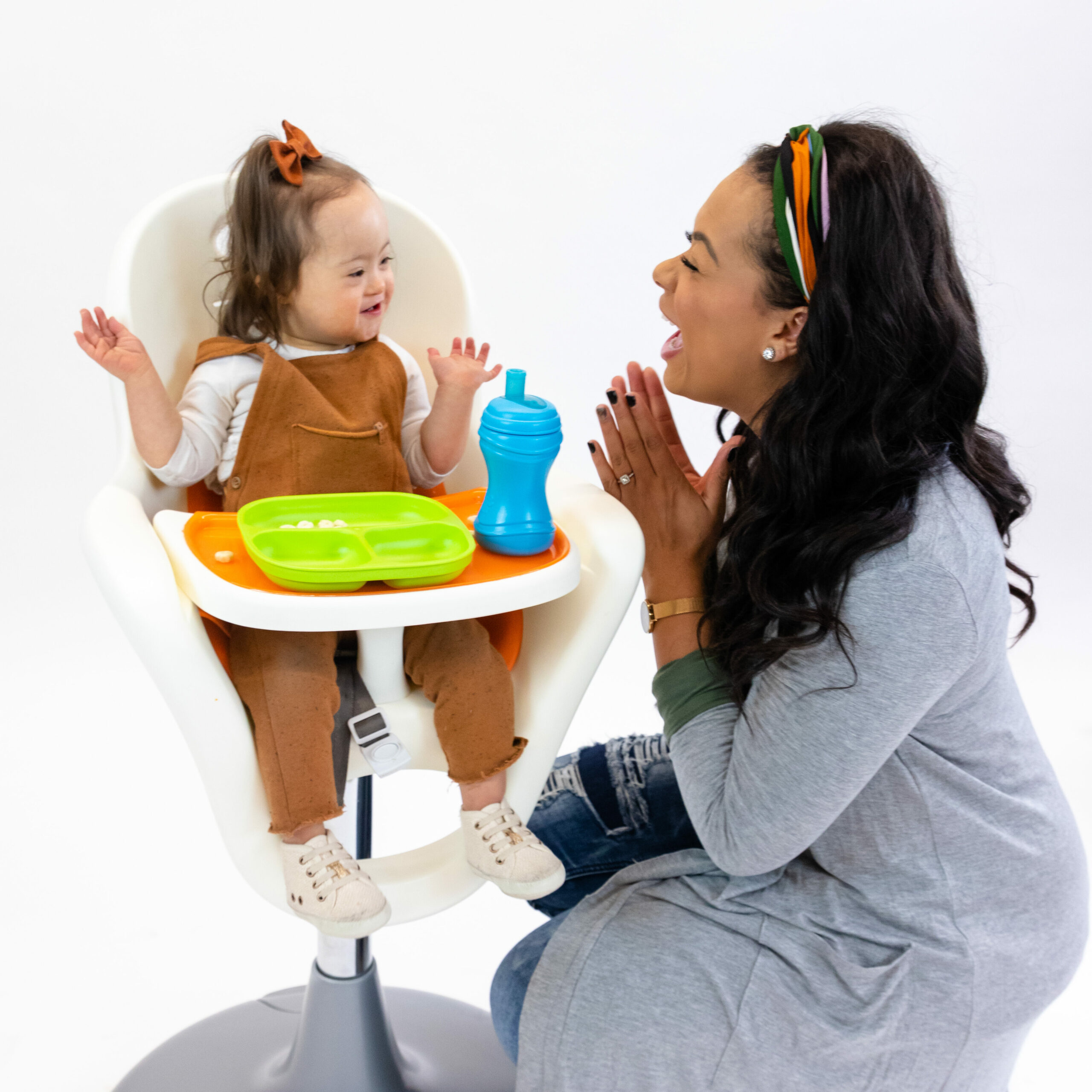 Mom feeding baby in a high chair